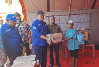 Direktur Utama PTAM Jayapura (Perseroda), Dr. Entis Sutisna, SE., M.Ak., menyerahkan bantuan air minum kepada korban kebakaran dok VIII Pantai.